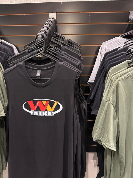 Rack of Western Village Health Club shirts